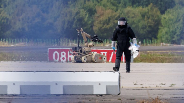 An investigator works with a robot capable of defusing explosives near a Ukrainian Antonov cargo plane at Leipzig/Halle Airport in Germany. 