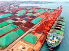 A cargo ship unloads imported iron ore at the Qingdao Port ore terminal in Qingdao, Shandong Province, China.