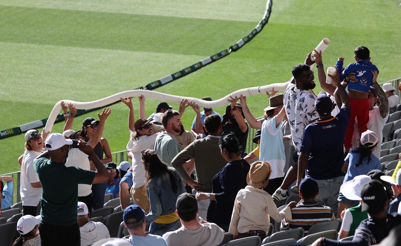 A beer cup snake is created at Perth Stadium.