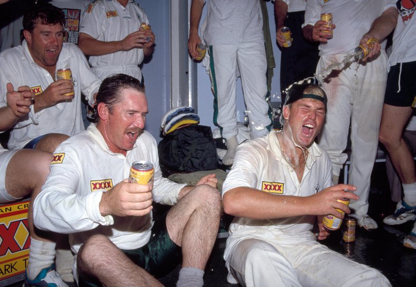The Australian captain Allan Border (left) and Shane Warne celebrate in the dressing room after the 1st Test match between England and Australia at Old Trafford in Manchester, 7th June 1993.