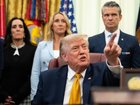 US President Donald Trump during an executive order signing ceremony this week as Pete Hegseth looks on.
