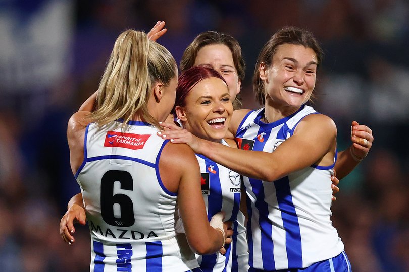 Alice O'Loughlin of the Kangaroos, Jenna Bruton of the Kangaroos, Tess Craven of the Kangaroos and Ash Riddell of the Kangaroos celebrate a goal during the AFLW Grand Final match between North Melbourne Kangaroos and Brisbane Lions.