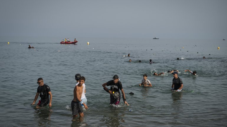 Migrants arrive on Tarajal beach after crossing the border between Spain and Morocco on July 31, 2026 in Ceuta, Spain. 