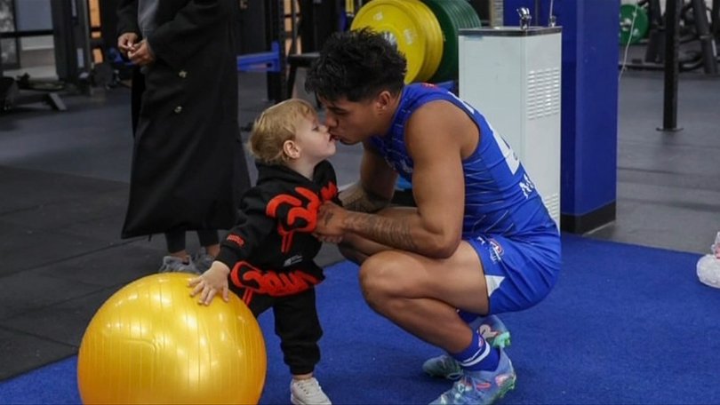 North Melbourne forward Paul Curtis and his son Elliot.