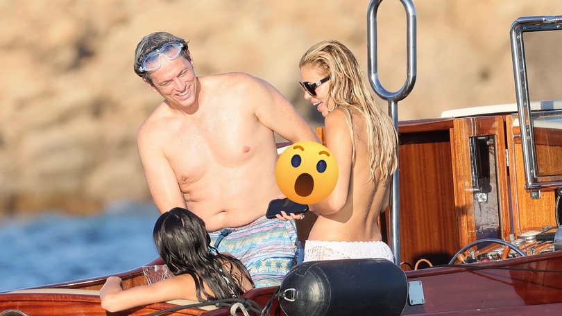 The 29-year-old bared her chest as she soaked up the sun on a family holiday in Sardinia, Italy on Sunday.