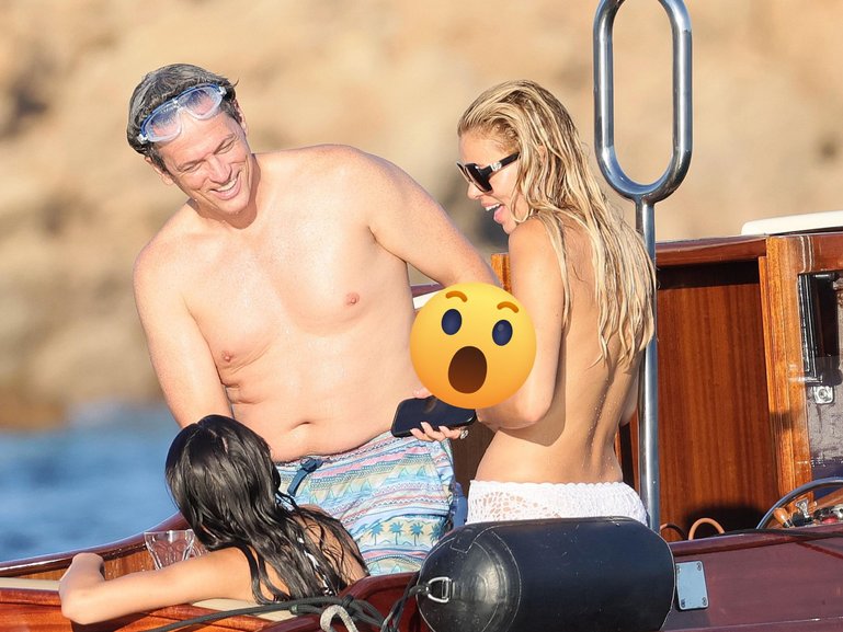 The 29-year-old bared her chest as she soaked up the sun on a family holiday in Sardinia, Italy on Sunday.