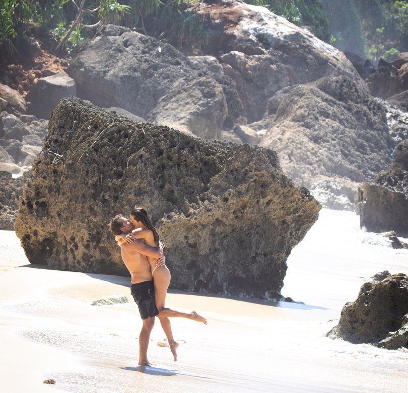 The couple embrace on the Indonesian beach.