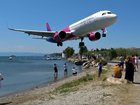 As passenger jets land at the airport, they skim over the heads of nearby onlookers.