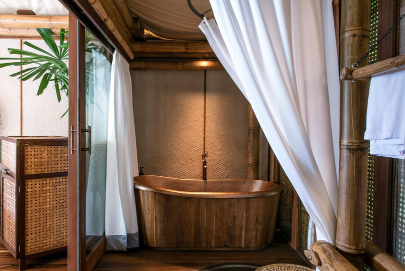 There are copper bathtubs, rain showers, twin basins, outdoor showers, comfy canopy beds, upscale coffee machine and 26 differing places to sit (yes, we counted them).