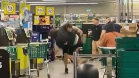 A shopper has been caught on camera tackling a man accused of assaulting four people inside a Woolworths store.