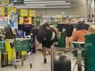 A shopper has been caught on camera tackling a man accused of assaulting four people inside a Woolworths store.