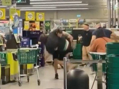 A shopper has been caught on camera tackling a man accused of assaulting four people inside a Woolworths store.