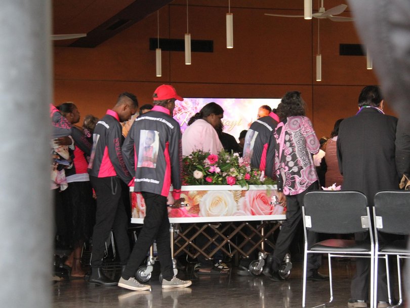 Family members stood around Kumanjayi Little Baby’s flower-covered coffin as the community joined them in grief. Picture; NewsWire/ Gera kazakov
