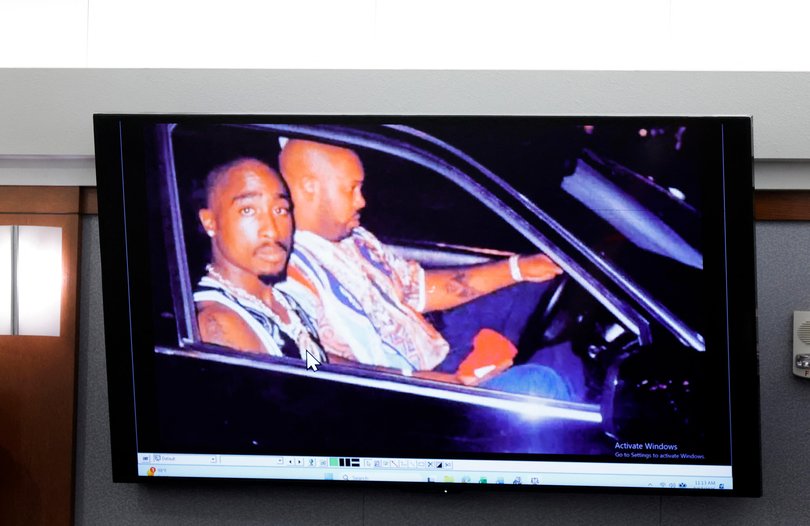 A 1996 photo of rapper Tupac Shakur, left, and Marion “Suge” Knight is displayed during the Duane Davis murder trial.
