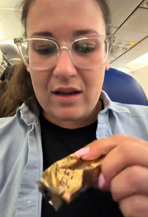 Madi was called out on the flight for eating the peanut chocolate bar.