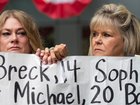 Victoria Hinks (L) and Lori Schott (R) hold hands as family members of young people who allegedly died from the impacts of social media demonstrate outside the Meta trial in California.