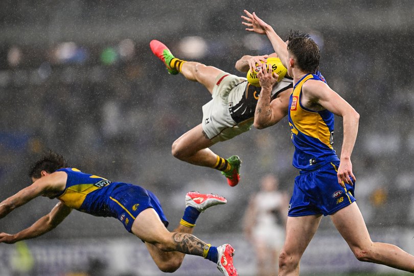 Nick Watson of the Hawks flies for a mark.
