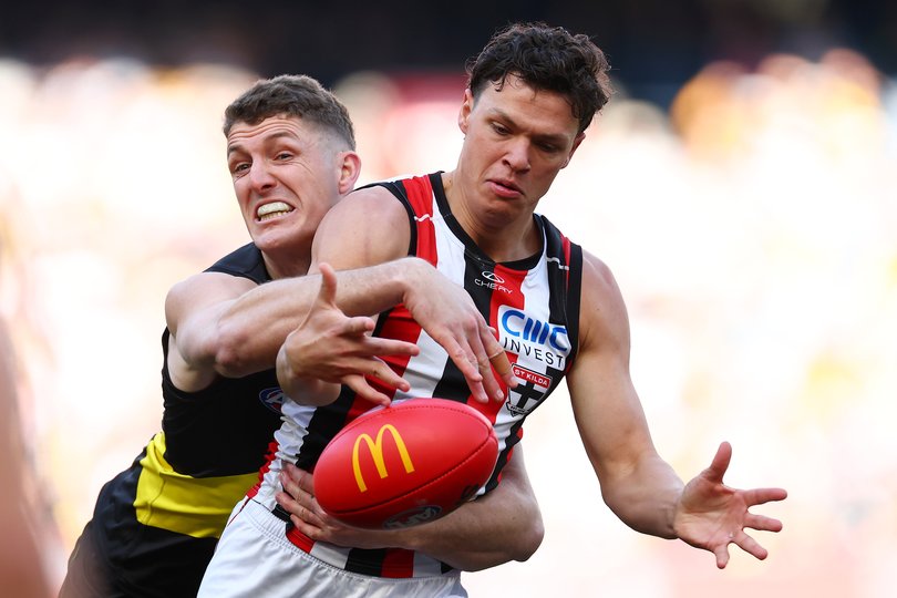 Marcus Windhager of the Saints is tackled by Ben Miller of the Tigers.