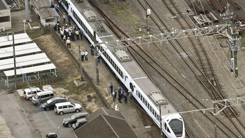 Four workers were killed while doing weed control on tracks at a Japanese train station. (AP PHOTO)
