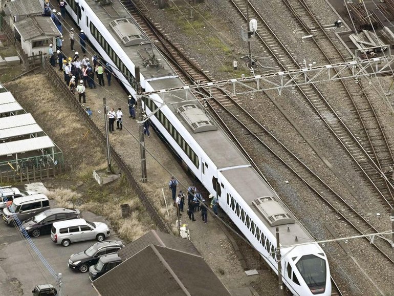 Four workers were killed while doing weed control on tracks at a Japanese train station. (AP PHOTO)