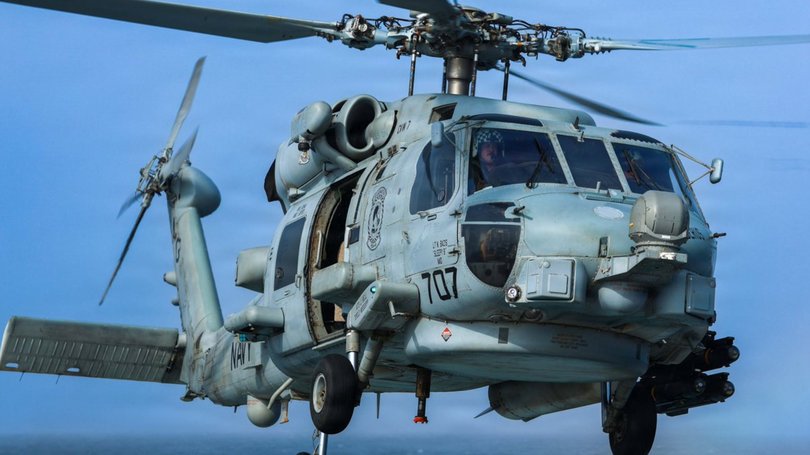 A post by US Central Command to X with the caption ' A U.S. Navy MH-60 Sea Hawk hovers over the flight deck of USS Mason (DDG 87) as the ship enforces America's steel wall blockade against Iran.’
