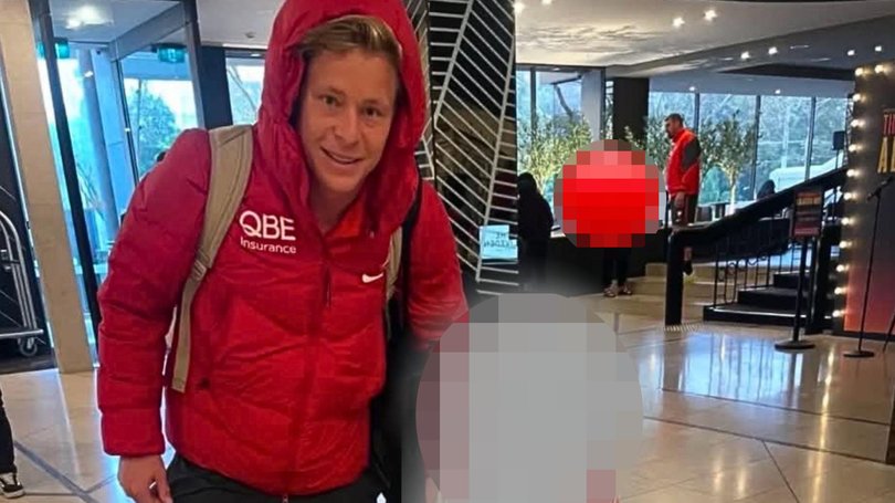 Heeney poses with a 5-year-old fan while Dean Cox can be seen talking to a woman in the background.