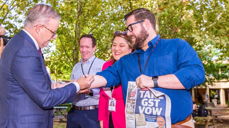 Prime Minister Anthony Albanese signs State Political reporter Dylan Caporn's arm at a press conference in Thornlie on Monday pledging WA's fair share of the GST deal. Kelsey Reid
