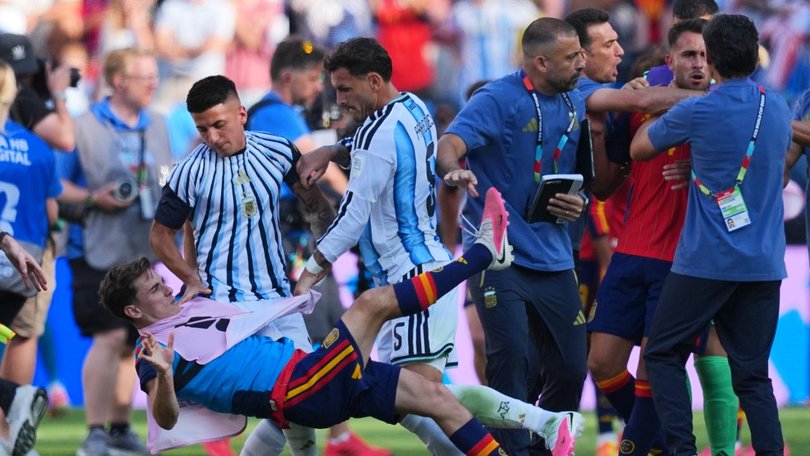 Leandro Paredes sends Spain's Gavi to the ground as Argentina coaches scuffle with Eric García.
