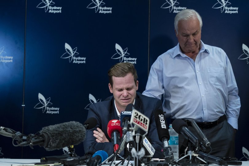 An emotional Steve Smith is comforted by his father Peter as he fronts the media at Sydney International Airport on March 29, 2018 in Sydney, Australia. 