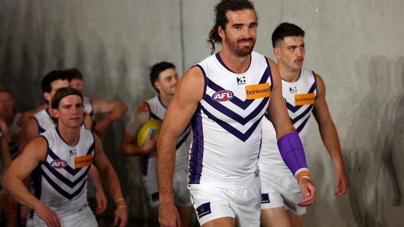 Alex Pearce of the Dockers leads his team out onto the field.