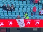 The Swans fan’s banner was removed by security during the AFLW game.