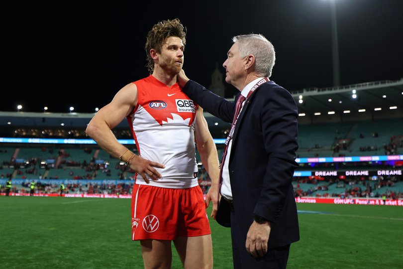 Dane Rampe is embraced by Swans chair Andrew Pridham.