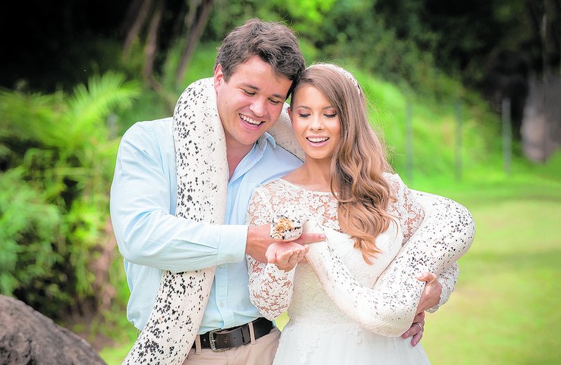 Chandler Powell and Bindi Irwin on their wedding day in 2020 with a python.