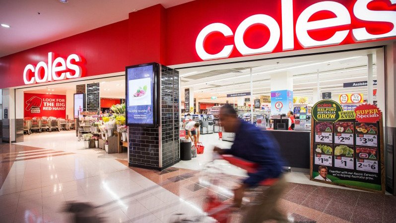 A shopper pushes a trolley outside a Coles supermarket in Sydney.