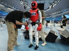 BEIJING, CHINA - AUGUST 24: Technical prepare the humanoid robots in the lightweight combat event during the 2nd World Humanoid Robot Games at National Speed Skating Oval on August 24, 2026 in Beijing, China. The second World Robot Games will be held in Beijing from August 22nd to 26th.  (Photo by Lintao Zhang/Getty Images)