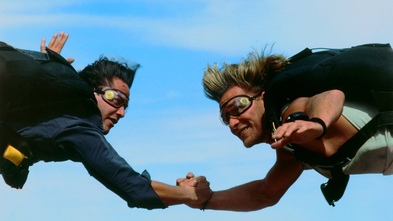 Utah and Bodhi hold hands on a random skydive.