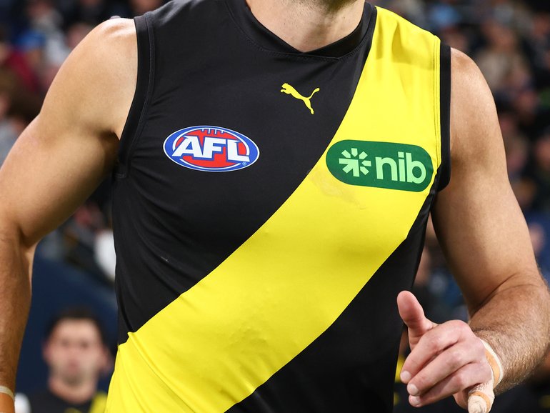 Toby Nankervis of the Tigers leads the team out.