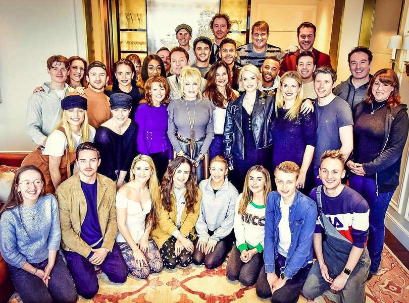 Dolly Parton pictured with the cast of 9 to 5 the musical.