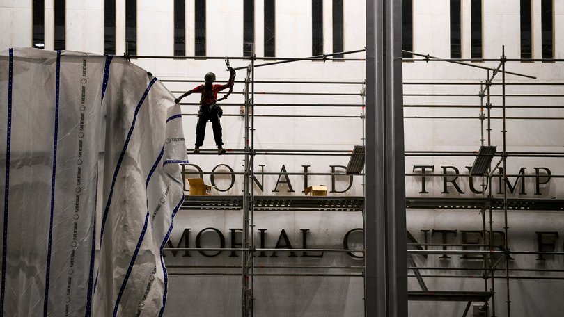 Workers removing Trump’s name from the Kennedy Centre.