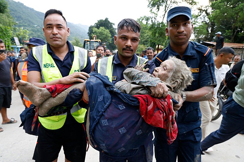 An elderly woman is rescued following the flash flooding in the Nuwakot district of Nepal.