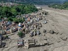 Houses lie partially submerged in muddy water along a riverside after flash floods at Trishuli Bazar in Nepal's Nuwakot district.