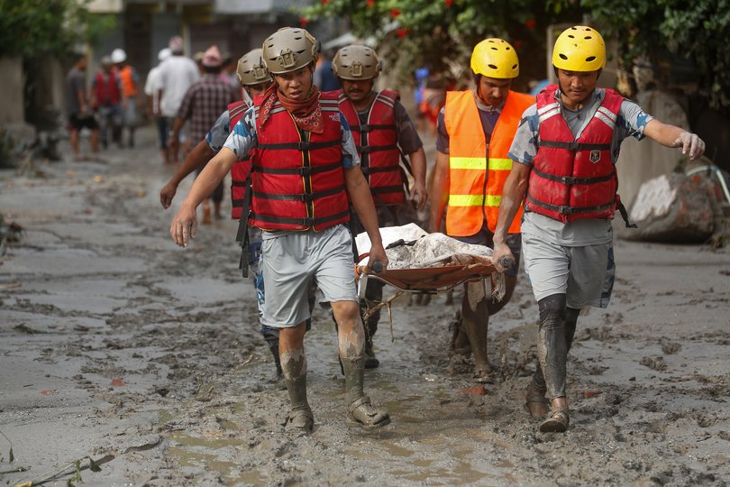 Security personnel collect the bodies of flood victims in Nuwakot, Nepal, on August 27, 2026, following an outburst of a glacial lake in Tibet. Rescue and recovery operations continue in the flood-affected area as authorities search for victims and assess the extent of the damage. (Photo by Sanjit Pariyar/NurPhoto via Getty Images)