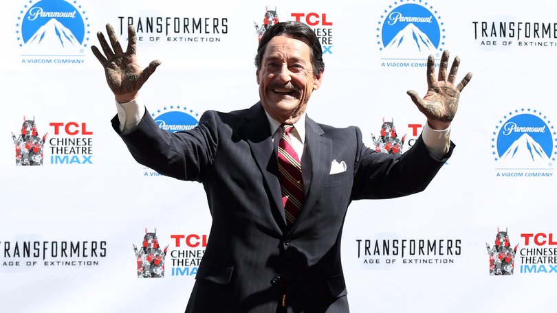 Actor Peter Cullen holds up his hands after placing them in the fabled cement during the world-famous handprint-footprint ceremony at the TCL Chinese Theatre IMAX on September 30, 2014 in Hollywood.