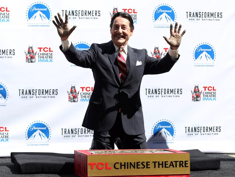 Actor Peter Cullen holds up his hands after placing them in the fabled cement during the world-famous handprint-footprint ceremony at the TCL Chinese Theatre IMAX on September 30, 2014 in Hollywood.