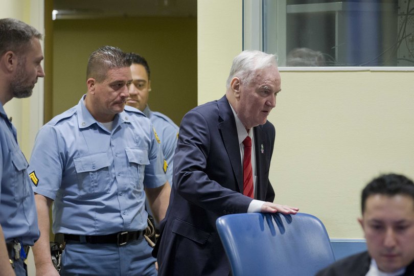 Ratko Mladic, the former Bosnian Serb general dubbed the ÒButcher of BosniaÓ for his actions during the Balkan wars of the 1990s, enters a courtroom in The Hague on Nov. 22, 2017.