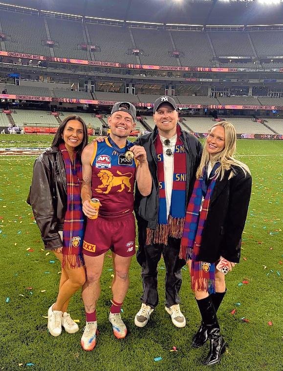 Lachie Neale and Jules Neale with Ben Crosley and Tess Crosley after Brisbane's 2025 Grand Final win.