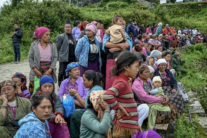 People wait in line to board rescue helicopters in the disaster-stricken Rasuwa district.