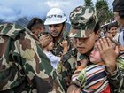 Children are carried to a rescue helicopter by military personnel in the disaster-stricken Rasuwa district near Nepal’s border with Tibet.