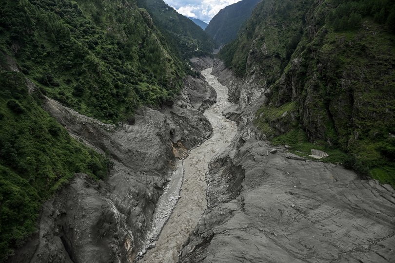 The banks of the debris-choked Bhotekoshi River show signs of the giant torrent of water, mud and ice that swept through the remote river valley.