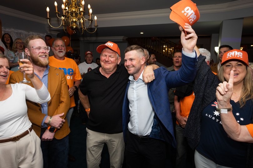 Luke Herdegan with his father and One Nation supporters.
